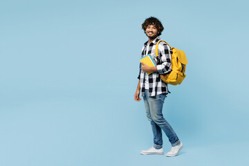 Full body side view happy young Indian boy student he wearing shirt casual clothes backpack bag...