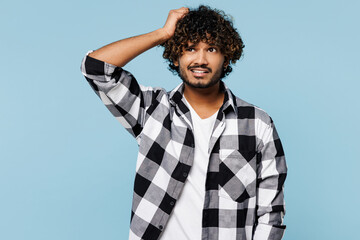 Young pensive minded sad Indian man wear shirt white t-shirt casual clothes look aside on area hold...