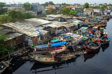 Fototapeta na wymiar portrait of traditional fishing boats in fishing village near the river that connects to the sea
