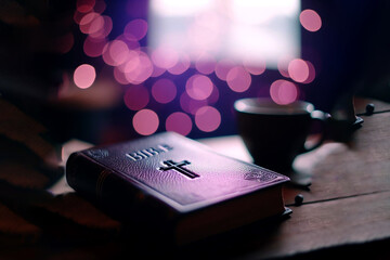 A bible on the table with the purple background