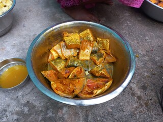 Raw cut Fish pieces,Raw cut Fish pieces mixing turmeric oil salt a woman hand on,Cutting raw fish on an Aluminium container,