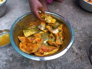 Raw cut Fish pieces,Raw cut Fish pieces mixing turmeric oil salt a woman hand on,Cutting raw fish on an Aluminium container,