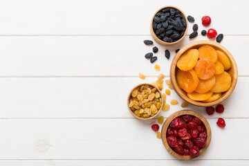 Bowl with different dried fruits on table background, top view. Healthy lifestyle with copy space