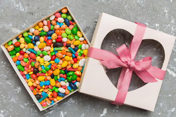 Box with sweet chocolate candies on color background, Various candy sweets. Valentines day gift box. Top view flat lay with copy space