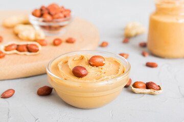 Bowl of peanut butter and peanuts on table background. top view with copy space. Creamy peanut pasta in small bowl