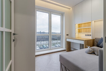 A modern teenager's room, with a sofa, a desk and a large window