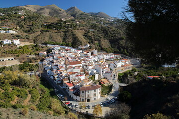 Obraz premium Aerial view of the village of Archez, Axarquia, Malaga province, Andalusia, Spain, with whitewashed houses and surrounded by mountains and trees
