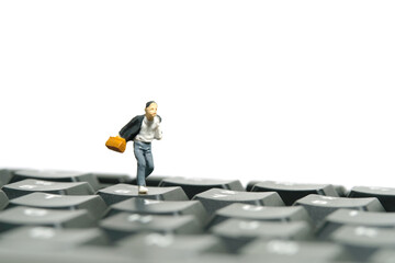 Miniature people toy figure photography. A boy pupil student running above keyboard. Isolated on a...