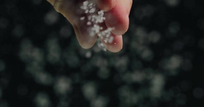 Chef pours salt, close-up low angle shot. Slow motion video