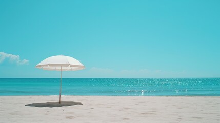 A solitary white beach umbrella offers a peaceful and minimalist scene on a pristine beach, perfect for relaxation and vacation themes with a vast, clear sky and tranquil sea.