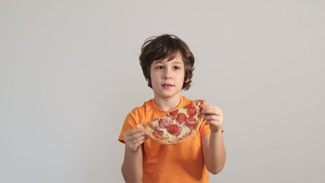 This candid shot of a child with a pizza 'smile' captures the innocence and creativity of youth, reminding us of the fun in life's simple pleasures.