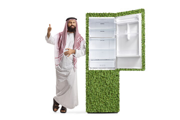Saudi arab man bag leaning on a power efficient fridge full of food and showing thumbs up