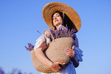 Beautiful woman in the lavender field on sunset in France
