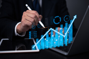 Data analysis graph and chart investment and marketing concept. Businessperson analyzing financial market trends on digital interface.
