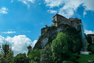 Fototapeta na wymiar Panoramic view of medieval castle Rabenstein on a hill in Frohnleiten, Murtal, Styria (Steiermark), Austria. Travel destination sunny day in summer. Surrounded by idyllic forest in foothills of Alps