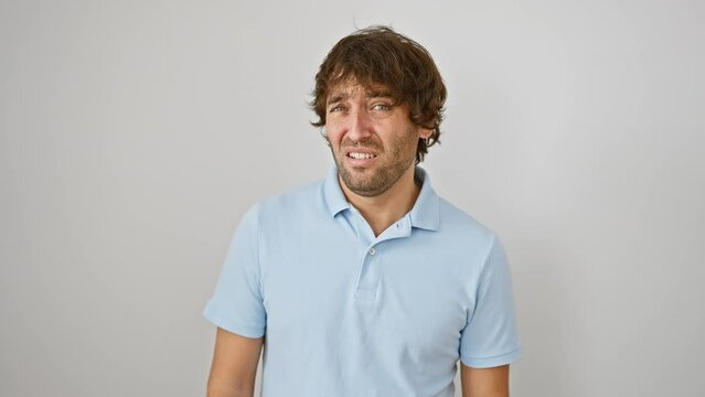 Stunned young caucasian guy sportin' skeptic face; a look of disbelief, mouth agape in surprise. picture of him standing, taken against plain white isolated background.