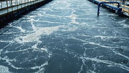 Process of purification effluent water flowing in outdoor channels at wastewater treatment plant facility. - Powered by Adobe