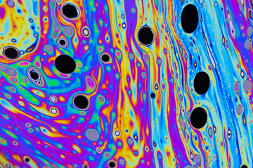 Macro photo of colourful pastel swirly patterns of a soap bubble