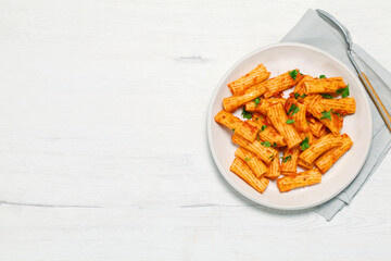 Plate of macaroni with tomato and parsley