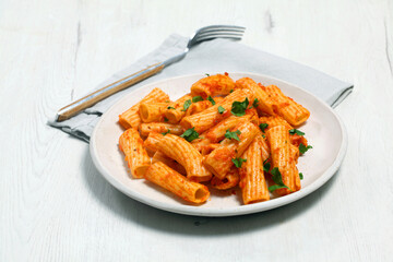 Plate of macaroni with tomato and parsley