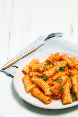 Plate of macaroni with tomato and parsley