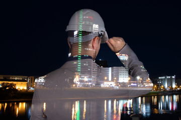 A double exposure of an engineer is superimposed on an image of a cityscape. The concept of...