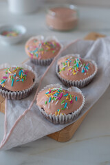 Chocolate cupcakes decorated with fresh cream raspberries 