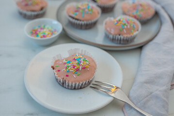 Chocolate cupcakes decorated with fresh cream raspberries 
