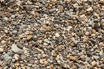 Background of small colored pebbles on the beach