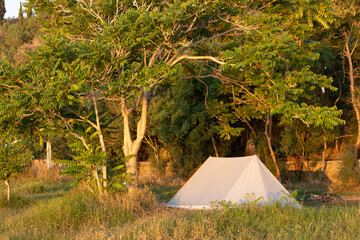 Camping with a tourist tent by the sea. Active lifestyle.