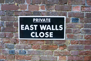 Private sign East wall Chichester. 