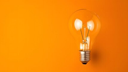 Isolated Light Bulb Floating in Vibrant Orange Space
