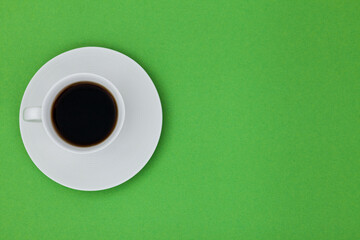 Fototapeta na wymiar Top view image of coffe cup on green paper background. Copy space for input the text. Flat lay. 