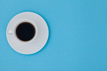 Top view image of coffe cup on blue paper background. Copy space for input the text. Flat lay.	