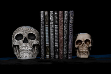 Antique embossed books with sculptured skull book ends with Smokey and spooky background Handmade