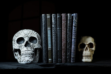 Antique embossed books with sculptured skull book ends with Smokey and spooky background Handmade