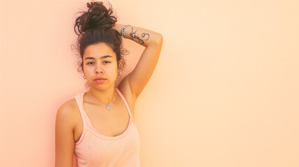 Young individual in a pastel tank top, with a temporary tattoo of an equality sign, posing against a plain pastel wall, representing the quiet strength in the equality movement - obrazy, fototapety, plakaty