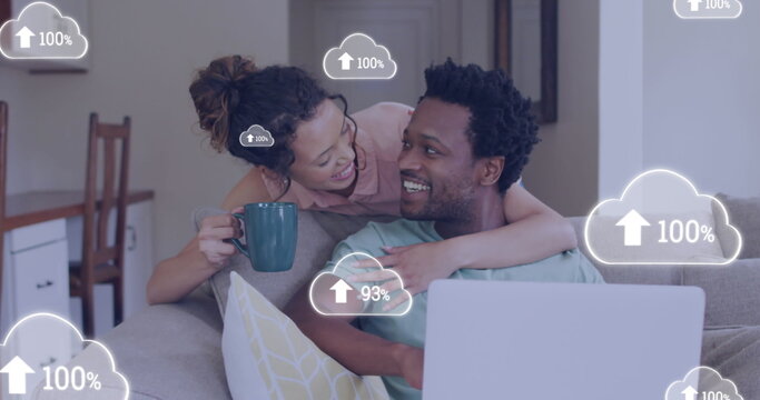 Image of cloud icons over african american couple using laptop