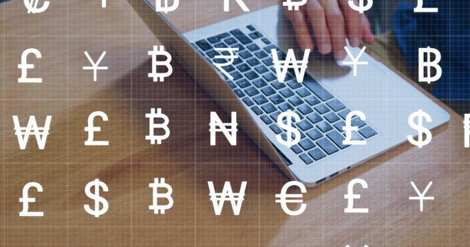 Image of currency symbols over hands using laptop