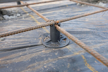 Preparation of reinforcement for the construction of a concrete slab, plastic stand for reinforcement close-up