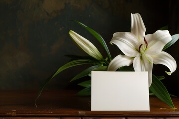 symbol of purity and new beginnings, a white lily stands tall next to a mysterious white envelope, casting a soft shadow on the wooden table