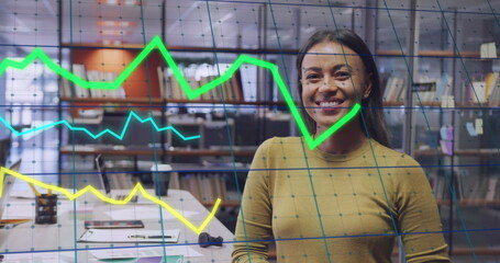 Image of data processing over biracial businesswoman smiling in office - Powered by Adobe