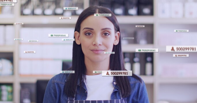 Image of media icons over caucasian female shop assistant smiling - Powered by Adobe