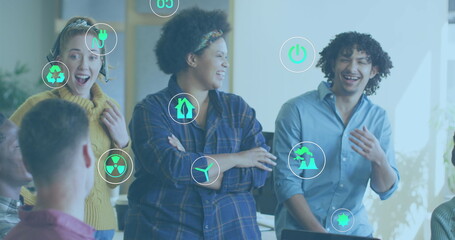 Image of ecology icons over diverse business people in office