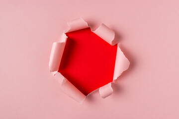 Vivid pink torn paper with burst hole background. Minimal abstra