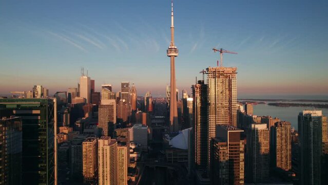 Gorgeous aerial of Toronto's CN Tower in evening lighting, 4K