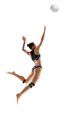 Obraz premium Dynamic portrait of woman, skilled, professional volleyball player training hits ball against white studio background. Concept of sport games, movement, championship, power and strength.