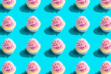 Colorful cupcake pattern on pastel blue background. Creative minimal party concept.