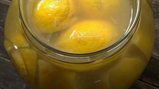 Top view of Moroccan-style preserved lemons in the jar. Table spin.
