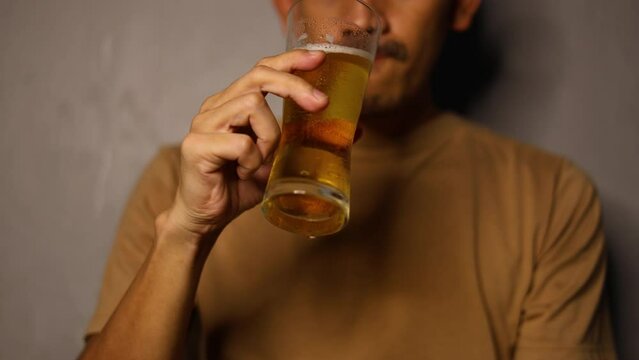 Men drinking beer. Portrait of men drinking beer and looking away